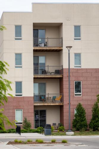 an apartment building with balconies and a street light at NEW HAPPY TRAIL 2BR CONDO CLOSE TO DOWNTOWN in Traverse City