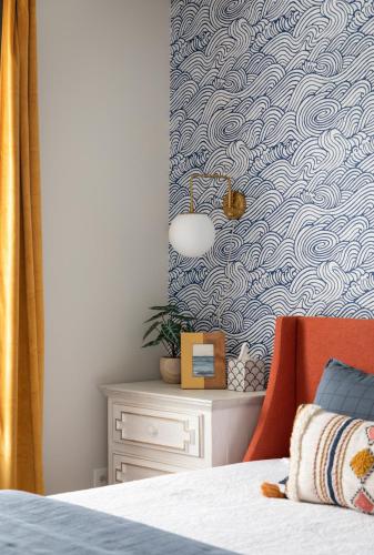 a bedroom with a bed with a blue and white wallpaper at NEW HAPPY TRAIL 2BR CONDO CLOSE TO DOWNTOWN in Traverse City