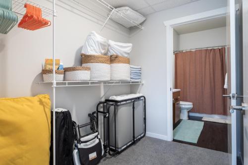 a room with a toilet and a closet with luggage at NEW HAPPY TRAIL 2BR CONDO CLOSE TO DOWNTOWN in Traverse City