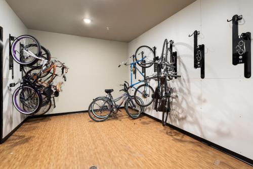 two bikes hanging on a wall in a room at NEW HAPPY TRAIL 2BR CONDO CLOSE TO DOWNTOWN in Traverse City