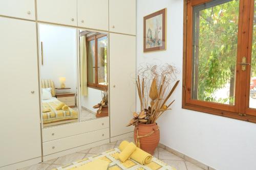 a room with a mirror and a vase on the floor at Spectacular villa near the beach! in Agia Paraskevi