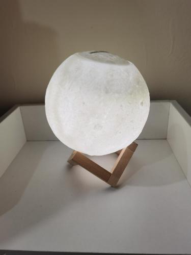 a white table on a wooden stand in a room at My Homestay Sitiawan - Astronaut Space House 8 Pax in Sitiawan
