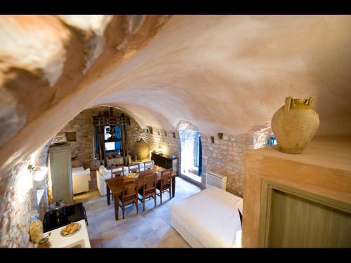 a living room with a table and chairs in a room at Arapakis Historic Castle in Pirgos Dhirou