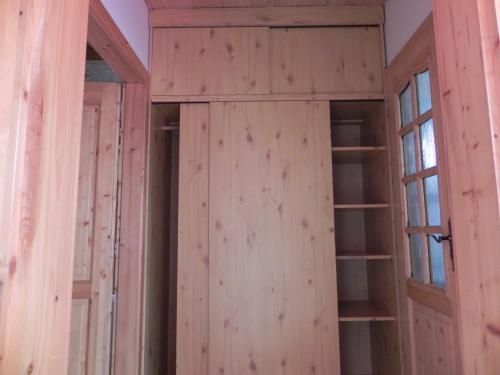 an empty room with wooden walls and windows at Penzion Krásný Dvůr in Krásný Dvŭr