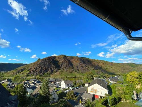 a view of a town with a mountain in the background at Fewo Burg,Mosel,Tal-Blick in Cochem