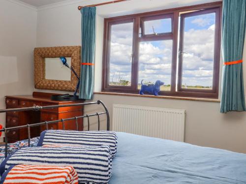 a bedroom with a bed and a window at Coastguard Cottage in Rye