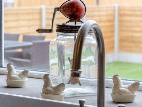a kitchen sink with a glass jar and rubber ducks at Dip Tub Den - Uk35989 in Wansford