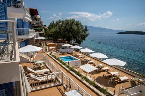 a view of a resort with a pool and chairs and umbrellas at Greek Beach House Complex B1 in Nydri
