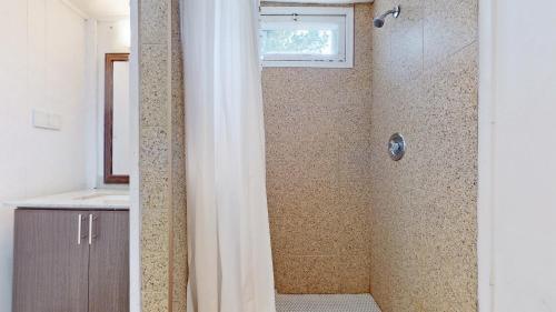 a bathroom with a shower with a shower curtain at Main Beach River Retreat - Wasaga Beach 1 - Main Strip - 93 Mosley St in Wasaga Beach