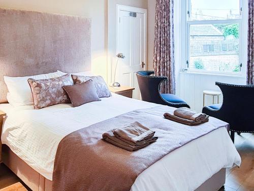 a bedroom with a bed with two towels on it at Inchkeith View in Edinburgh