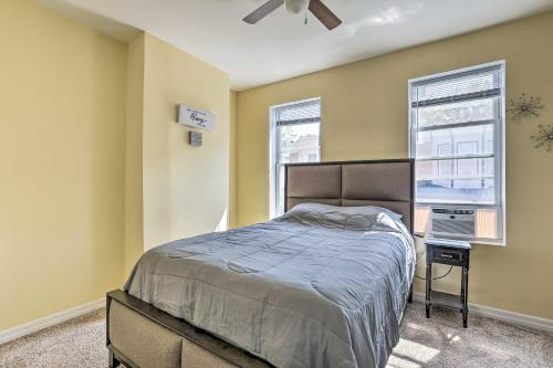 a bedroom with a bed and two windows at Philly Townhome with Gas Grill about 5 Mi to Dtwn! in Philadelphia