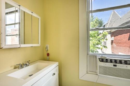 a bathroom with a white sink and a window at Philly Townhome with Gas Grill about 5 Mi to Dtwn! in Philadelphia