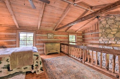 a bedroom with a bed in a log cabin at Turkey Hollow Cabin with Stunning Open Views! in Clyde