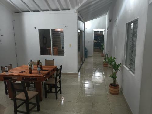 a dining room with a wooden table and chairs at coliving el jardín de Envigado in Envigado