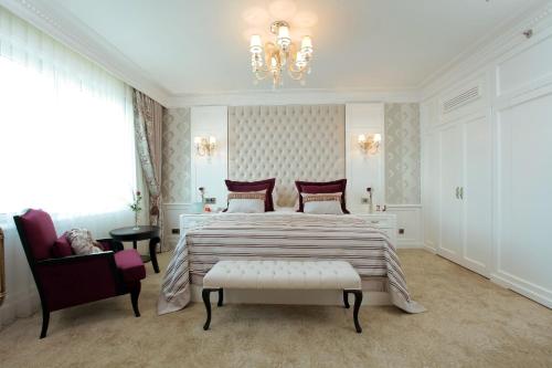 a bedroom with a large bed and a chandelier at WOW Istanbul Hotel in Istanbul