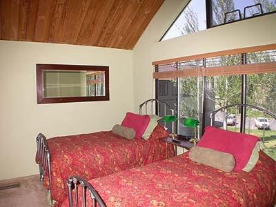 a bedroom with two beds and a window at Ala WaiApartment in South Lake Tahoe