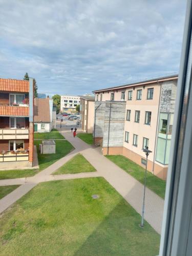 a view from a window of a street with buildings at Pigeon apartment in Kuldīga