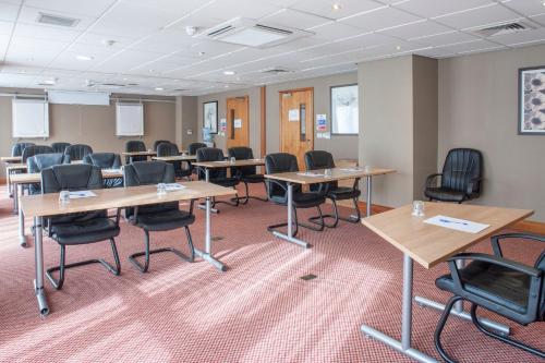 a classroom with desks and chairs in a room at Holiday Inn Express Birmingham Star City by IHG in Birmingham