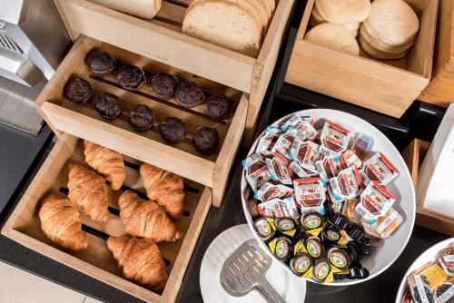 a bunch of different types of bread and pastries at Holiday Inn Express Birmingham Star City by IHG in Birmingham