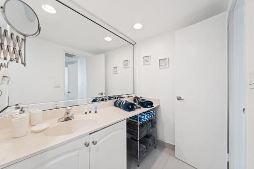 a bathroom with a sink and a large mirror at Spectacular Beach Condo!!! in Hollywood