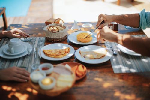 a table with plates of food on top of it at VILA ATY LODGE in Atins