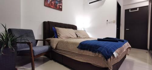 a bedroom with a bed and a chair in it at Aldridge Residence Executive Suite 2B@Shah Alam in Shah Alam