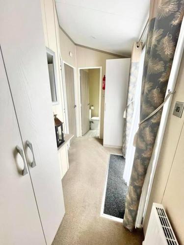 a room with a hallway with a room with a bathroom at 48 Pony Meadow - White Cross Bay in Windermere