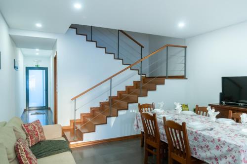 a dining room with a table and a staircase at Sailorman and Friends in Ponta Delgada
