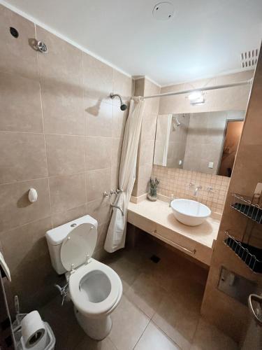 a bathroom with a toilet and a sink at Departamentos MITRE in Mendoza