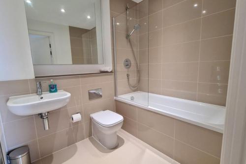 a bathroom with a toilet and a sink and a shower at Lowen in Newquay