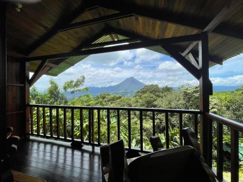 a room with a balcony with a view of a mountain at Casa Torre Eco- Lodge in Fortuna