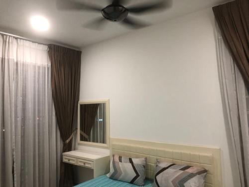 怡保的住宿－R&C Homestay 5，一间卧室配有吊扇和一张带镜子的床