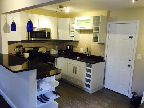 a kitchen with white cabinets and a black counter top at 2 bd 1 bth near DC! 7081 in Arlington