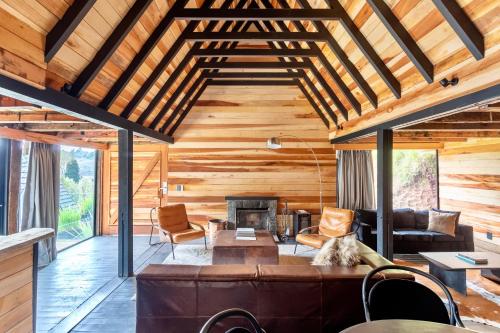 a living room with a couch and a fireplace at Ort Hotel in Campos do Jordão