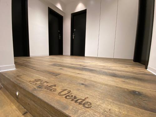 a room with a wooden floor with a sign that reads middle turtle at IL TIGLIO VERDE in Foggia