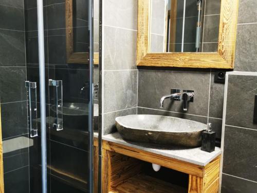 a bathroom with a sink and a glass shower at Appartement cosy en duplex, 8 pers, parking, Les Gets - FR-1-598-59 in Les Gets