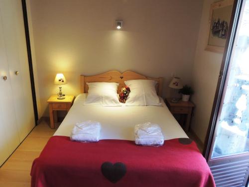 une chambre avec un lit avec deux sacs dessus dans l'établissement Appartement T2 au pied des pistes, cœur de village - 3 étoiles - 4 personnes - FR-1-598-65, aux Gets