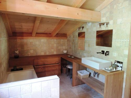 a bathroom with a tub and a sink and a bath tub at Chalet chaleureux 4* aux Gets, 3 niveaux, 6 pers., terrasse, poêle à bois, wifi - FR-1-598-10 in Les Gets