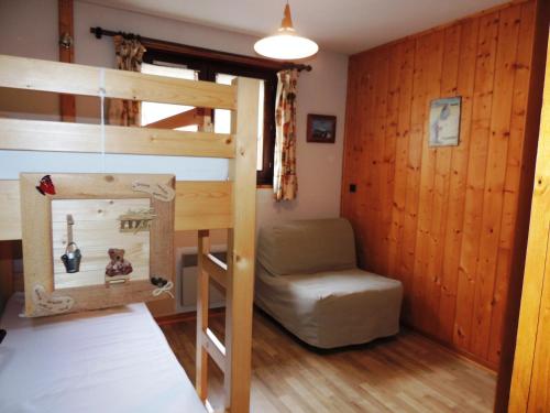 a bedroom with a bunk bed and a chair at Appartement Les Gets, 3 pièces, 5 personnes - FR-1-598-73 in Les Gets