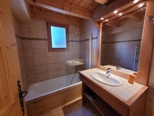 a bathroom with a sink and a bath tub and a sink at Appartement spacieux, 3 pièces + mezzanine, parking, Wifi - FR-1-598-79 in Les Gets