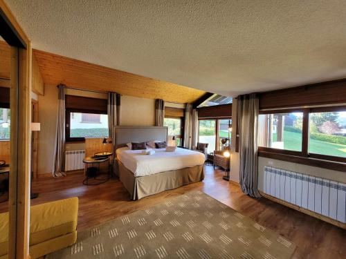 a bedroom with a bed in a room with windows at Appartement de Luxe 6 Pièces Pied des Pistes au Centre du Village - Les Gets - FR-1-598-26 in Les Gets