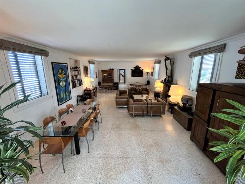 a living room with a couch and a table and chairs at logis la marine in Sidi Ifni