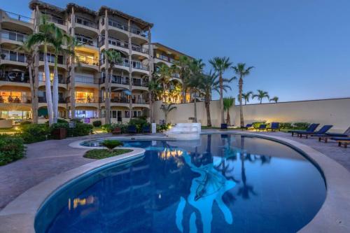 a swimming pool in front of a building at Sub- Penthouse Las Olas Surfers Paradise in San José del Cabo