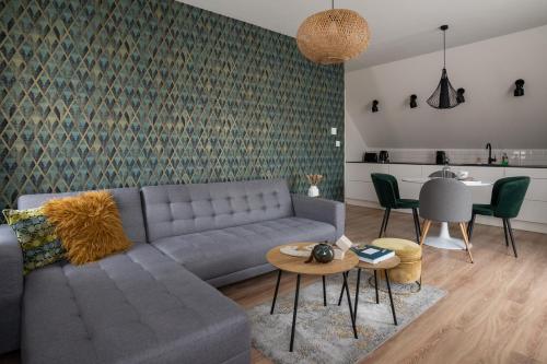 a living room with a couch and a table at Cesar Apartman in Sopron