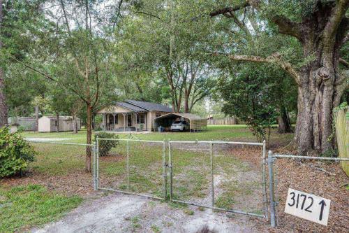 a gate in front of a yard with a house at Moody Woods in Orange Park