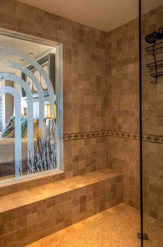 a bathroom with a shower and a mirror at Tortuga-World Class Ocean Front Villa5 500ft in San José del Cabo