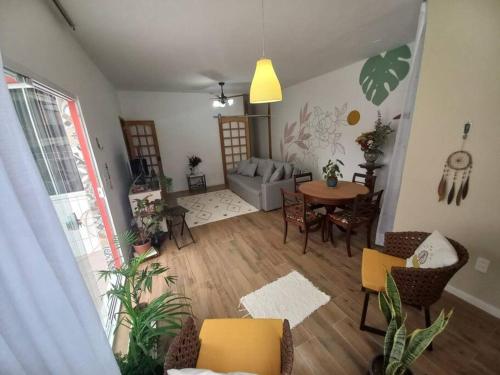 a living room with a couch and a table at Espaço, Conforto e vista para o Cristo no Rio. in Rio de Janeiro