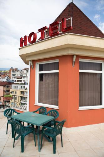 a restaurant with a table and chairs on a roof at Hotel Deva in Sandanski