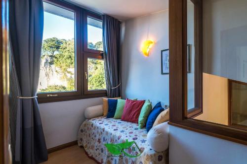 a room with a couch in front of a window at Villa vacacional Coto Blanco in Nueva de Llanes
