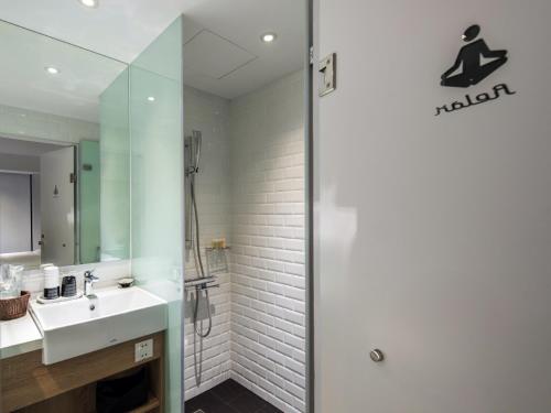 a bathroom with a sink and a shower at Hotel Relax III in Taipei